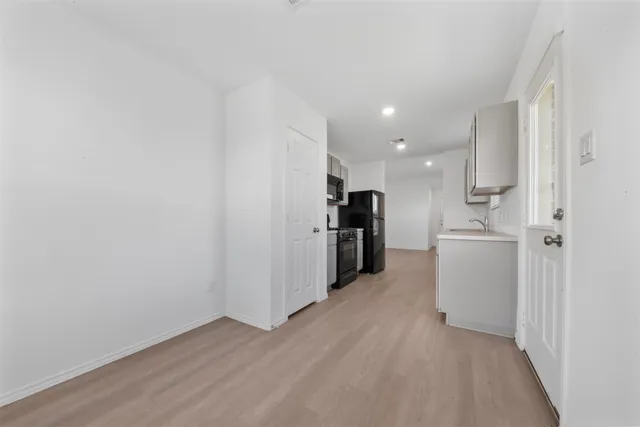 a view of a kitchen with a sink and a refrigerator