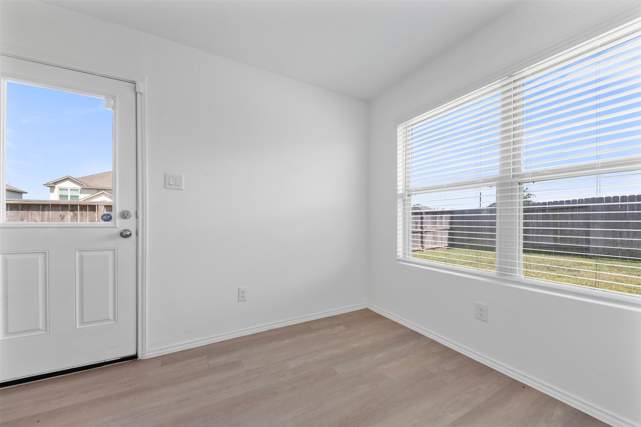 14506 Broadbury Pond Road Rosharon, TX 77583 - Photo 12 of 25 a view of an empty room with wooden floor and a window