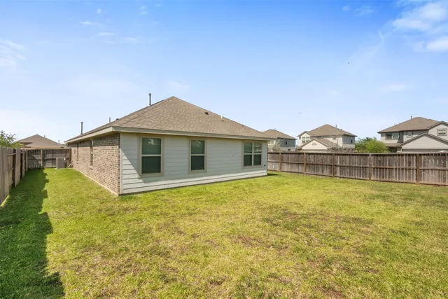 a view of a house with pool and a yard