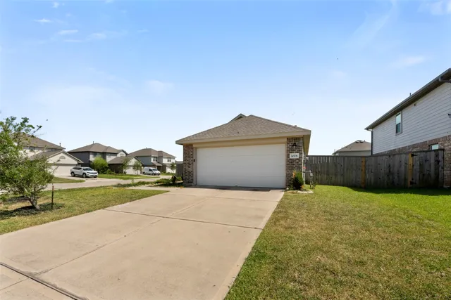 a view of a house with a yard and garage