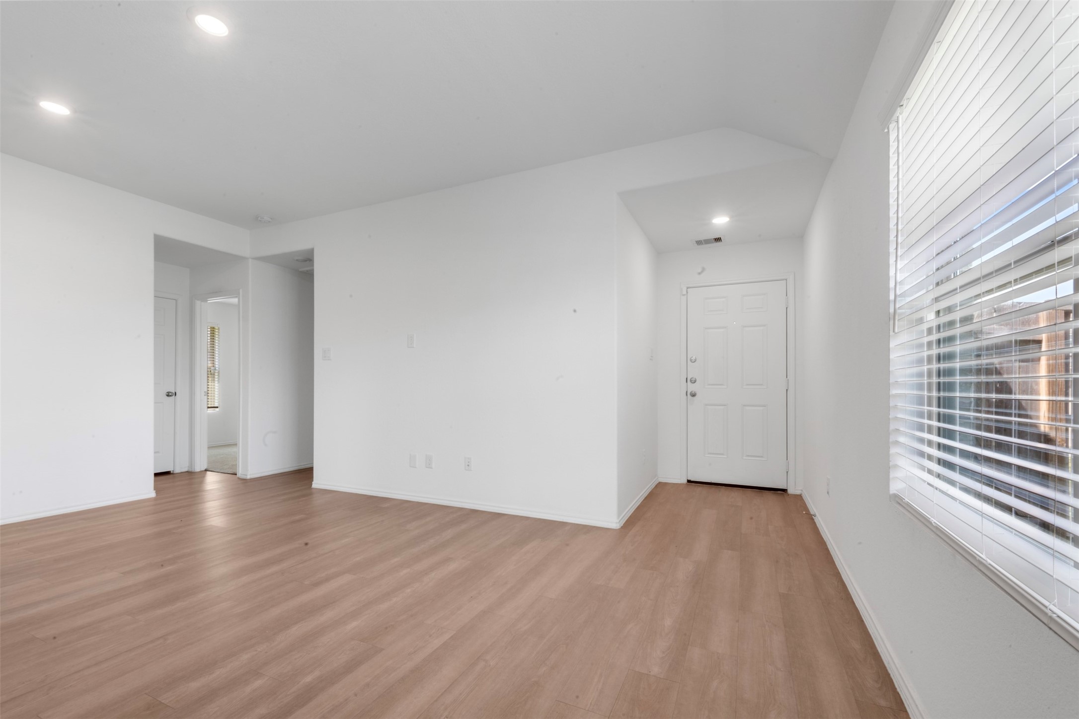 14506 Broadbury Pond Road Rosharon, TX 77583 - Photo 4 of 25 a view of an empty room with wooden floor and a window