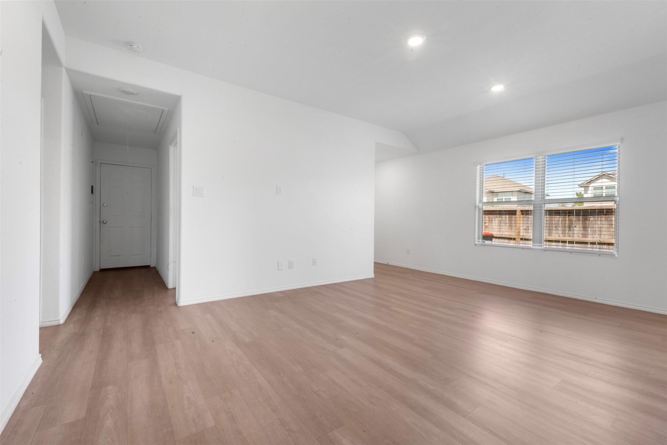 14506 Broadbury Pond Road Rosharon, TX 77583 - Photo 5 of 25 an empty room with wooden floor and windows