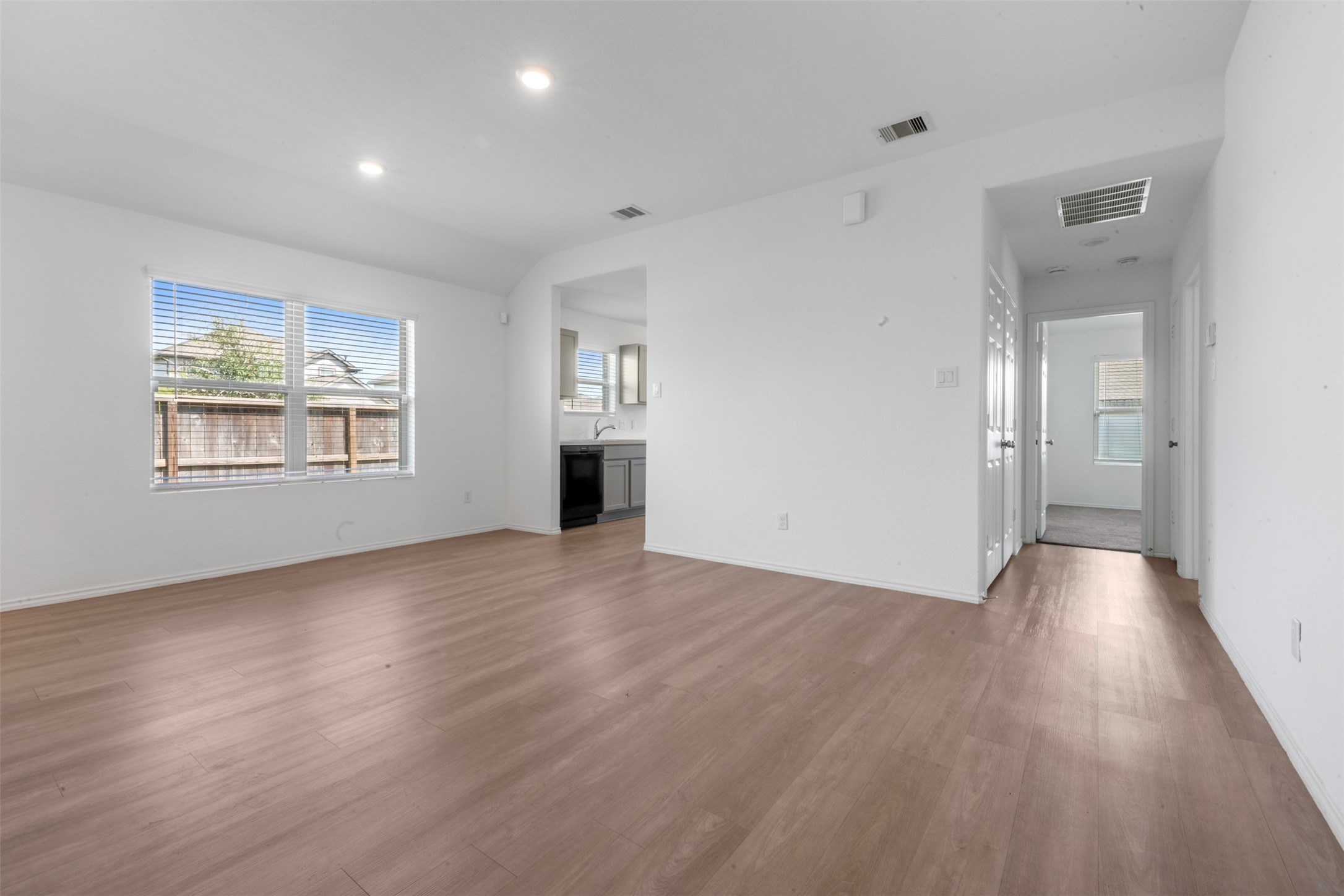 14506 Broadbury Pond Road Rosharon, TX 77583 - Photo 6 of 25 an empty room with wooden floor and windows
