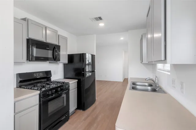 a kitchen with granite countertop stainless steel appliances and wooden cabinets