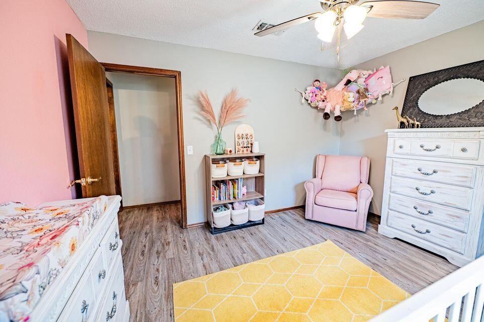 2914 Kermit Drive Plainview, TX 79072 - Photo 12 of 18 a bedroom with a bed and wooden floor