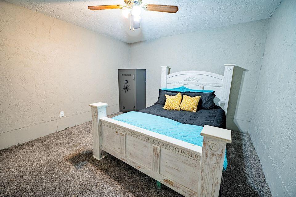 2914 Kermit Drive Plainview, TX 79072 - Photo 16 of 18 a bedroom with a bed and a chandelier