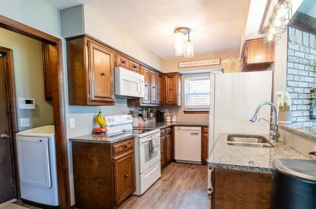 a kitchen with a sink cabinets and window