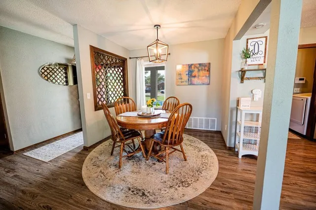a view of a dining room with furniture window and wooden floor