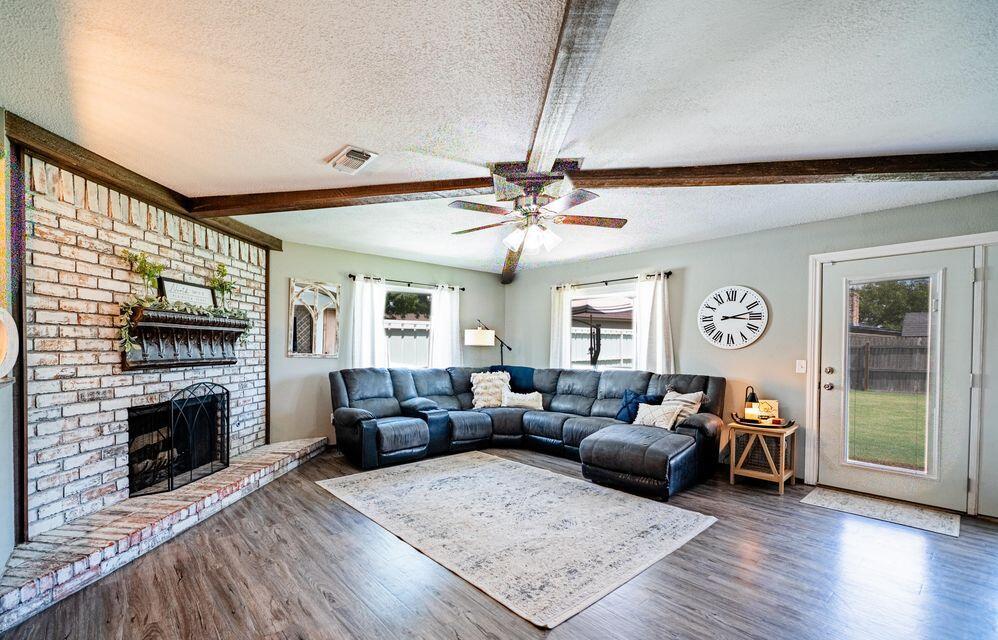2914 Kermit Drive Plainview, TX 79072 - Photo 7 of 18 a living room with furniture a fireplace and a flat screen tv