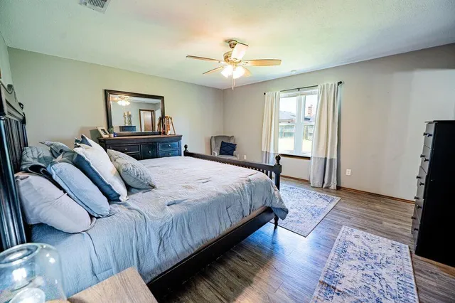 a bedroom with a bed and a chandelier