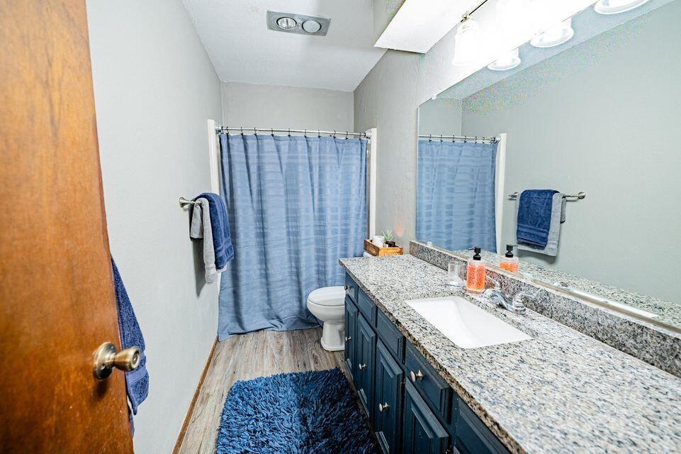 2914 Kermit Drive Plainview, TX 79072 - Photo 10 of 18 a bathroom with a granite countertop sink a mirror and shower