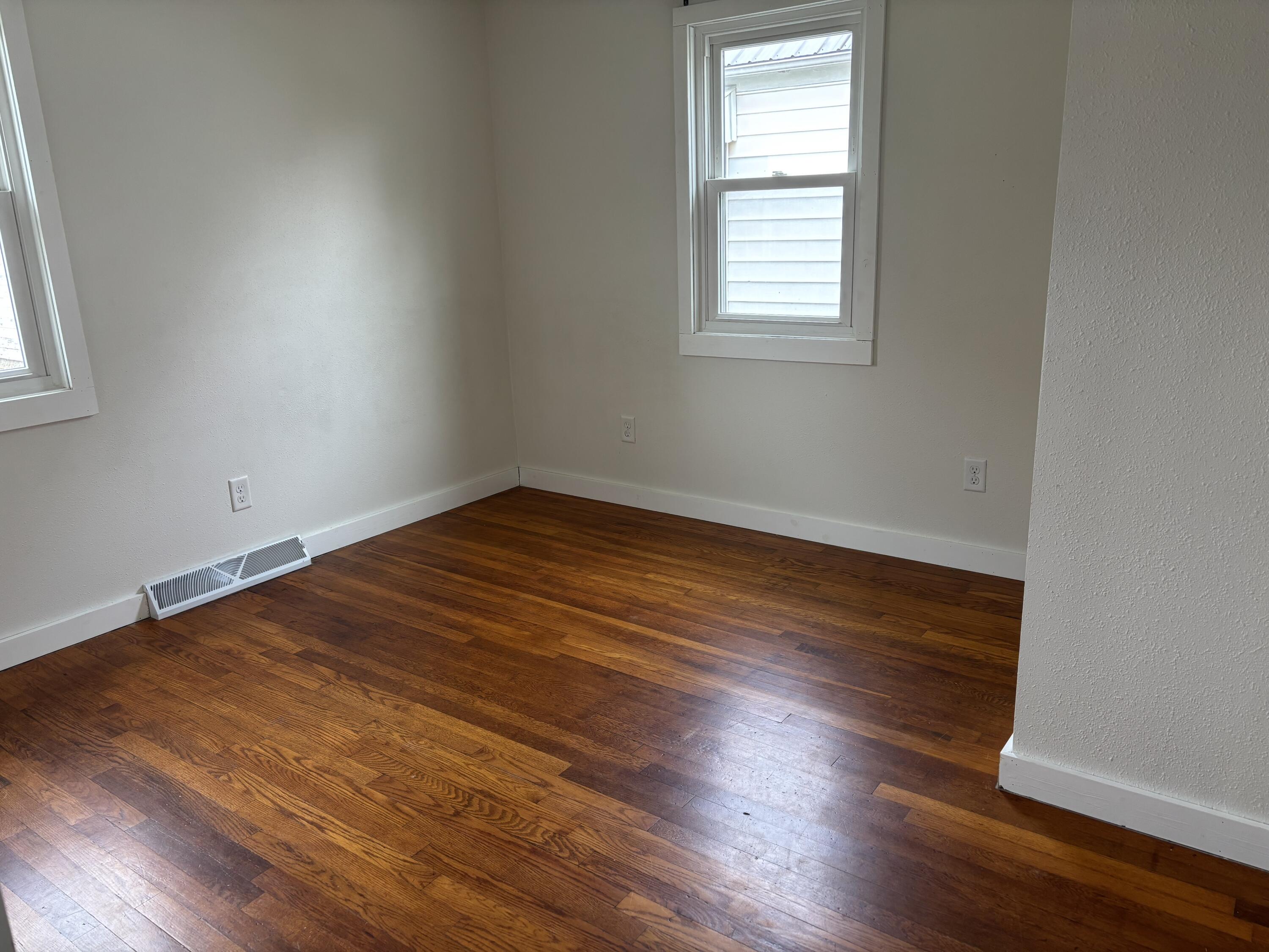 212 South Milton Street Rensselaer, IN 47978 - Photo 11 of 14 an empty room with wooden floor and windows