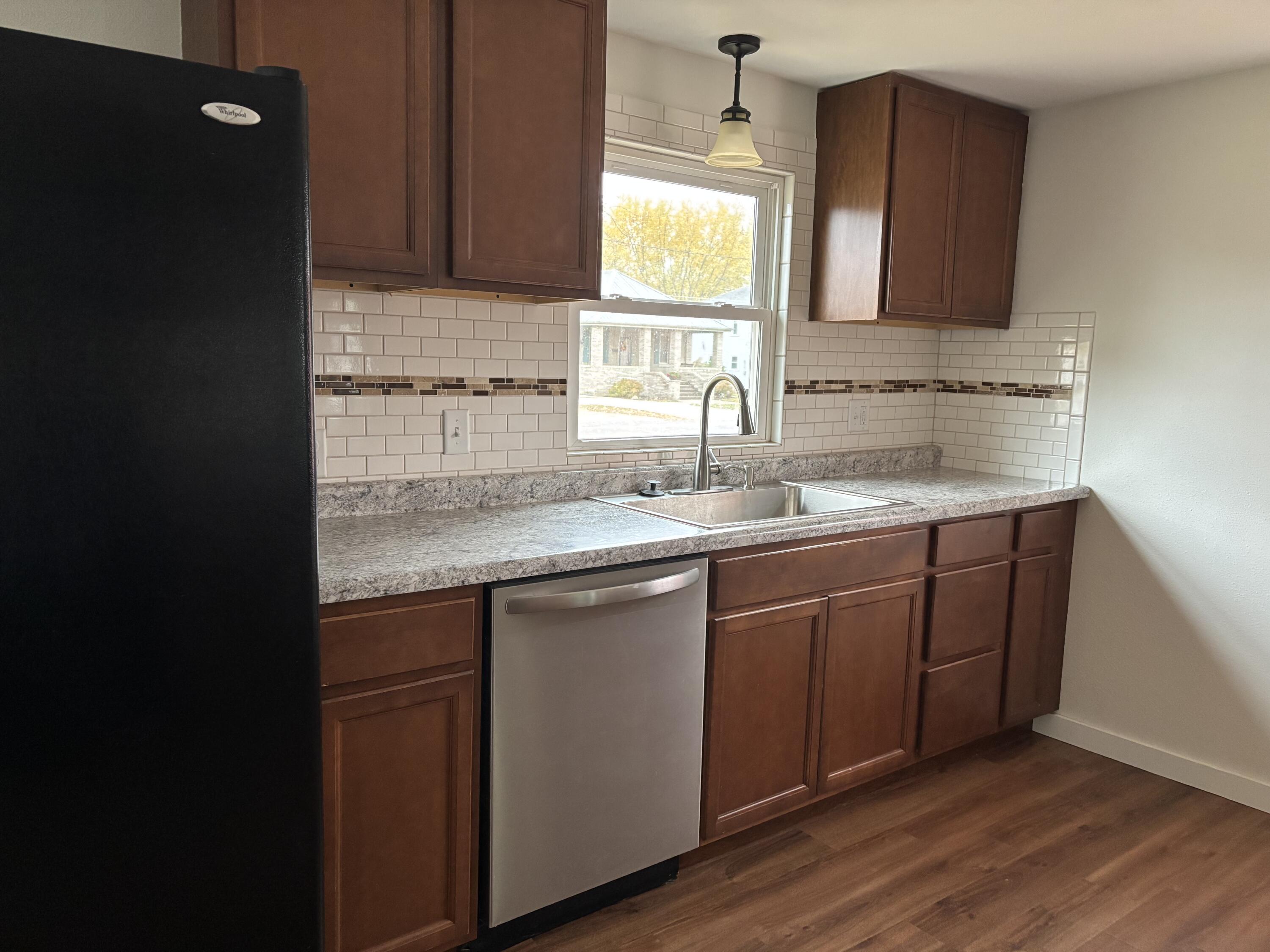 212 South Milton Street Rensselaer, IN 47978 - Photo 3 of 14 a kitchen with a sink cabinets and wooden floor