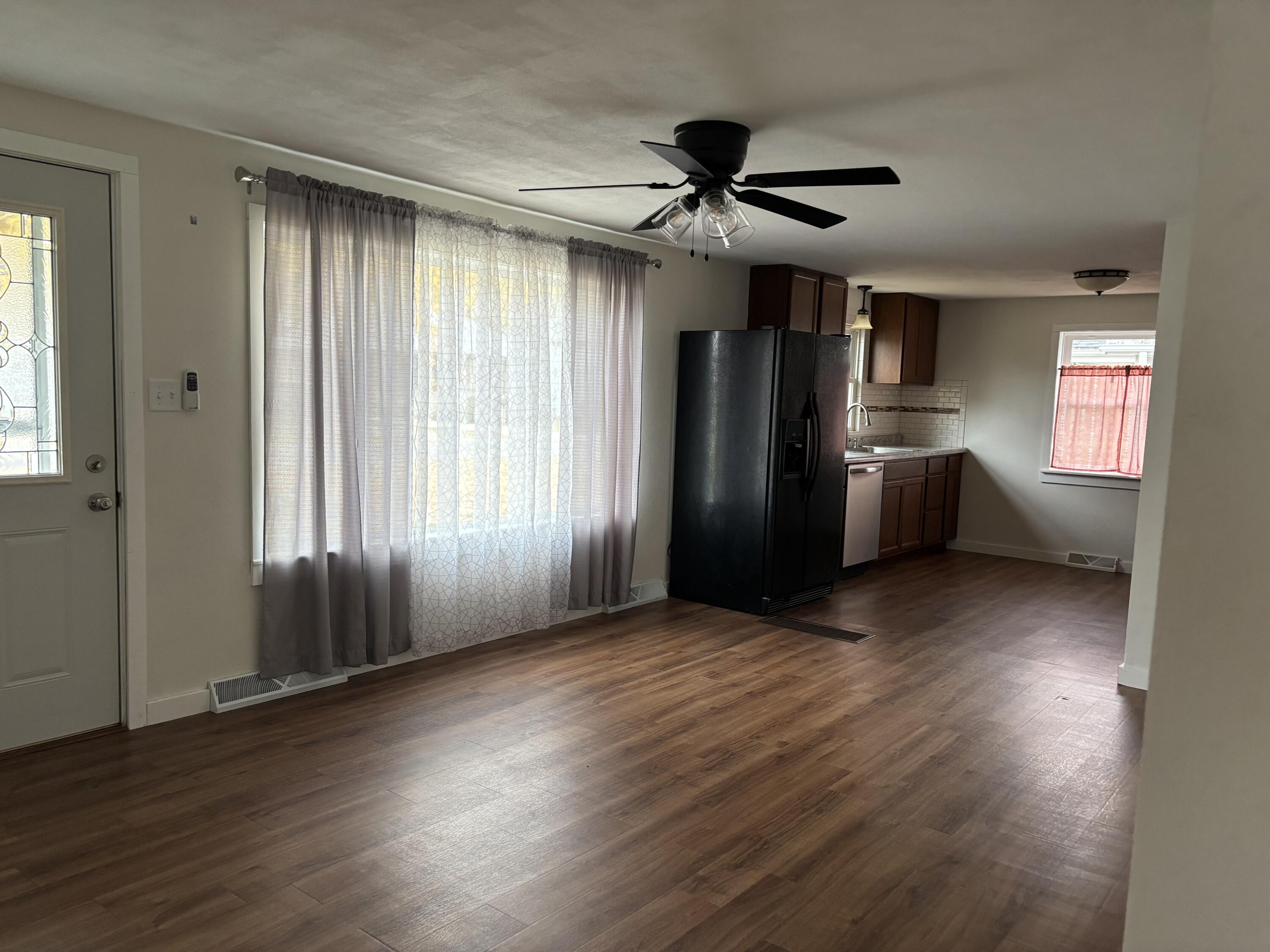 212 South Milton Street Rensselaer, IN 47978 - Photo 5 of 14 an empty room with wooden floor cabinet and windows