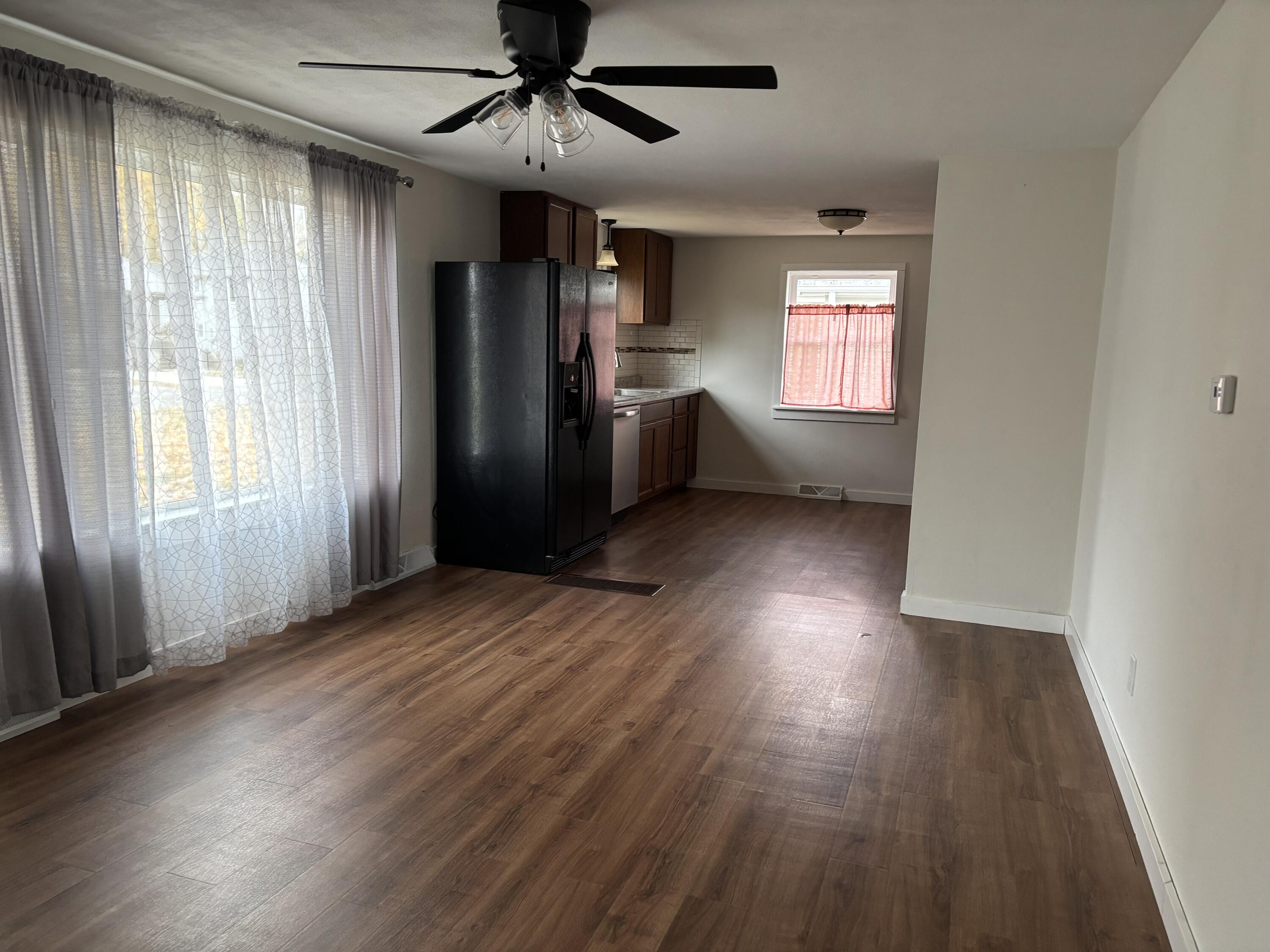 212 South Milton Street Rensselaer, IN 47978 - Photo 6 of 14 a view of an empty room with a window and wooden floor