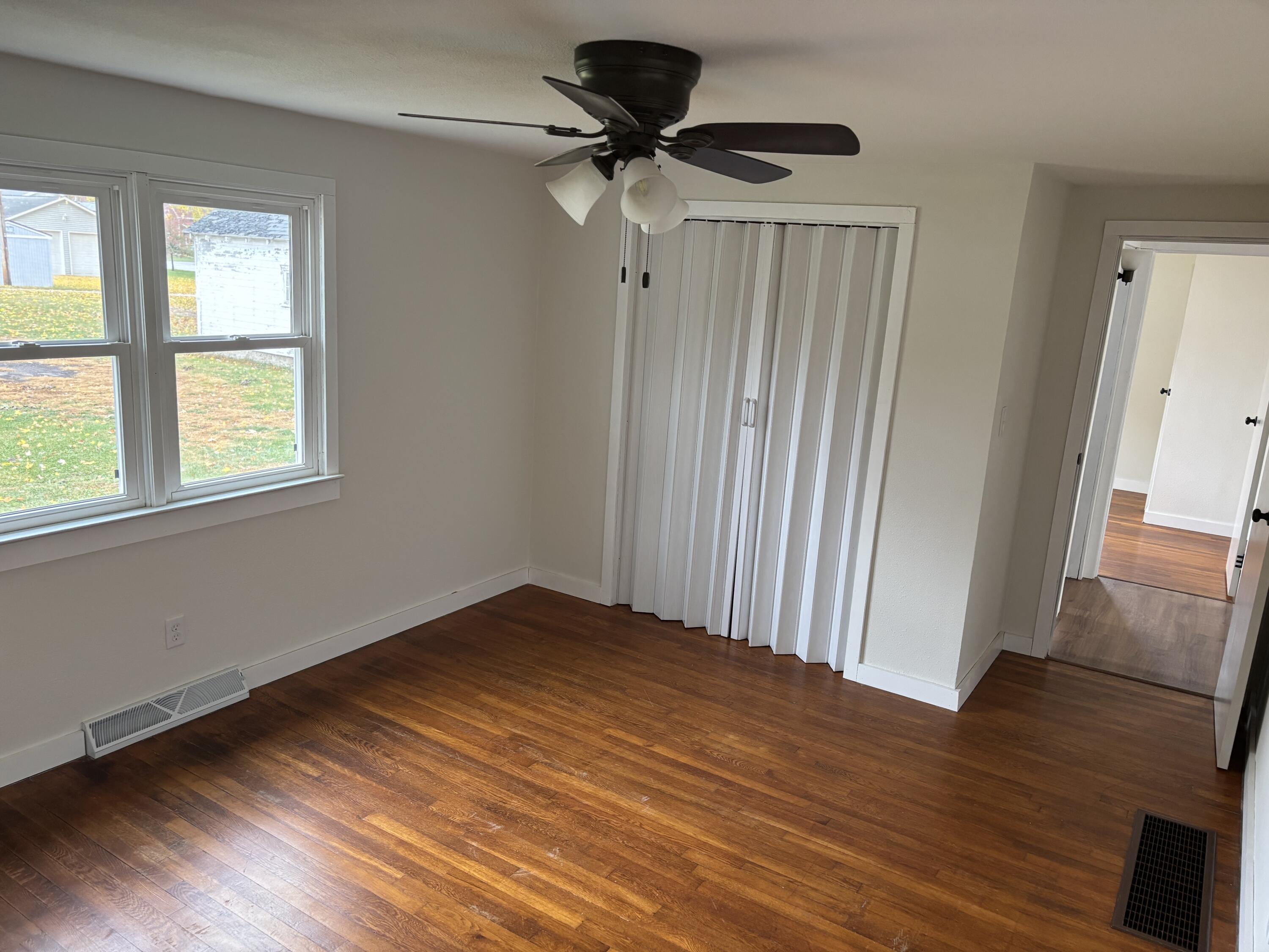 212 South Milton Street Rensselaer, IN 47978 - Photo 8 of 14 a view of empty room with wooden floor and fan
