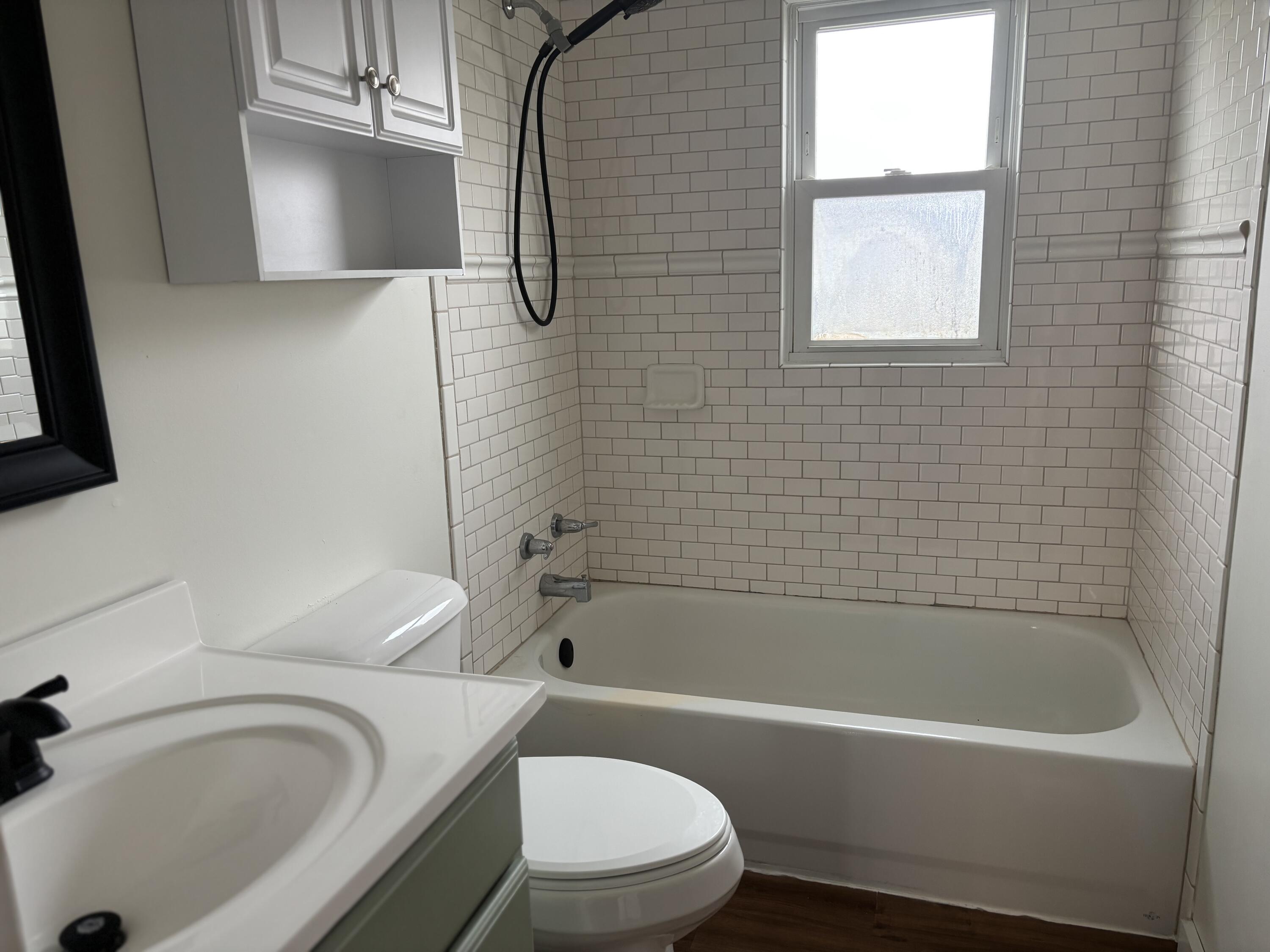 212 South Milton Street Rensselaer, IN 47978 - Photo 9 of 14 a bathroom with a sink a toilet and bathtub