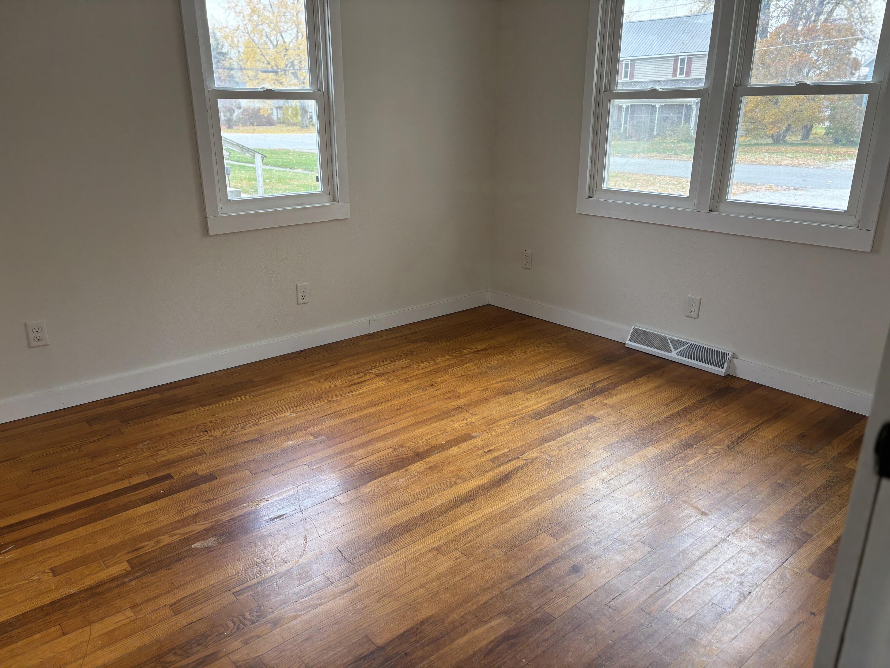 212 South Milton Street Rensselaer, IN 47978 - Photo 10 of 14 an empty room with wooden floor and windows