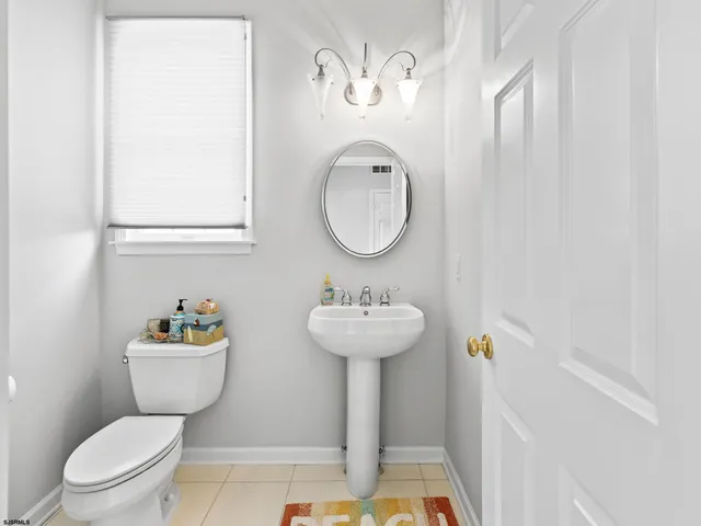 a bathroom with a sink mirror toilet and a shower