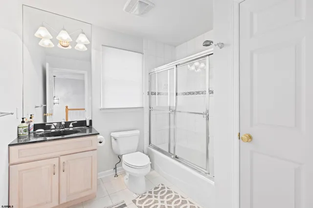 a bathroom with a toilet a sink and a mirror