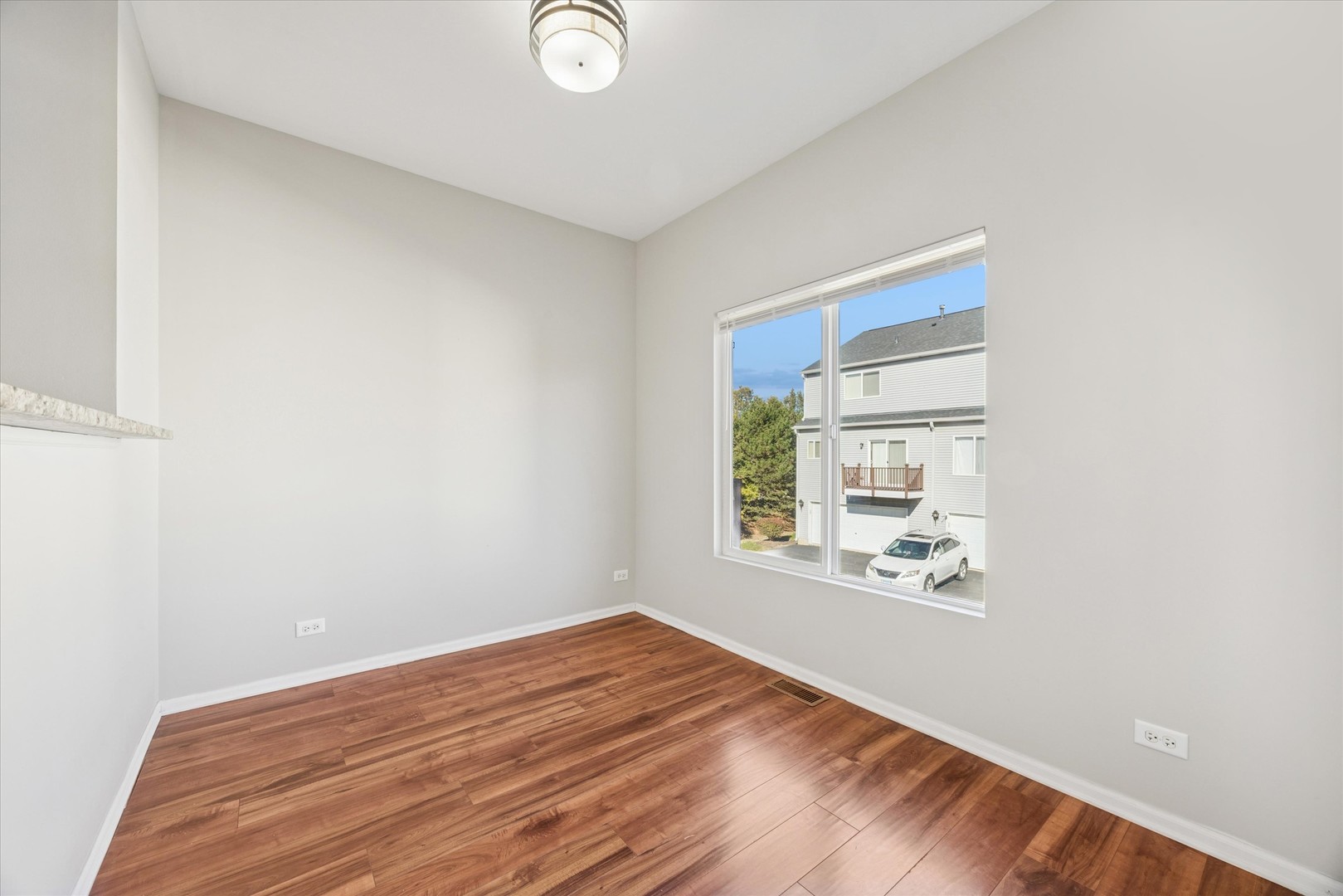 117 Enclave Circle, Unit C Bolingbrook, IL 60440 - Photo 5 of 19 a view of empty room with wooden floor and fan