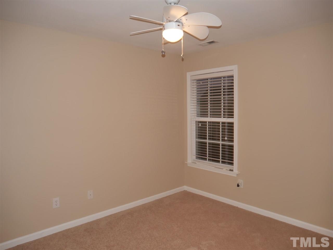 2300 Persimmon Ridge Drive Raleigh, NC 27604 - Photo 13 of 20 an empty room with a window and a fan