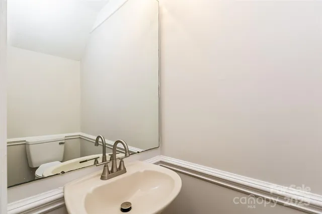 a bathroom with a sink and mirror