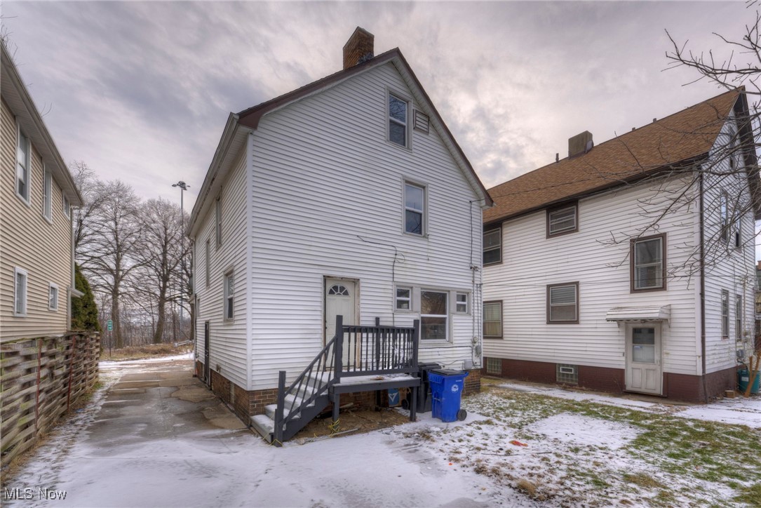 4324 Riverside Avenue Cleveland, OH 44102 - Photo 4 of 8 Snow covered rear of property featuring a chimney
