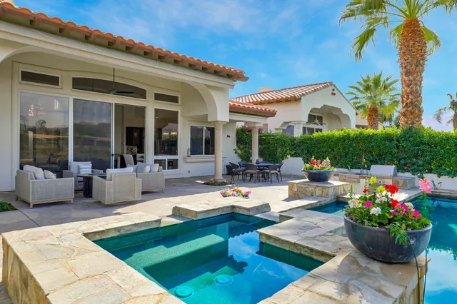 a swimming pool with outdoor seating and yard