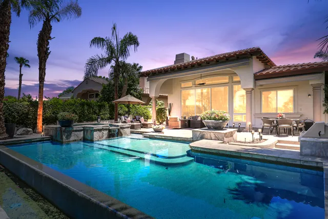 a view of a house with swimming pool outdoor seating