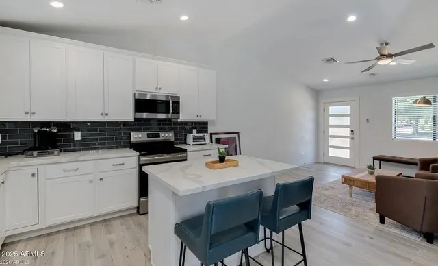 a kitchen with a stove a sink and a refrigerator