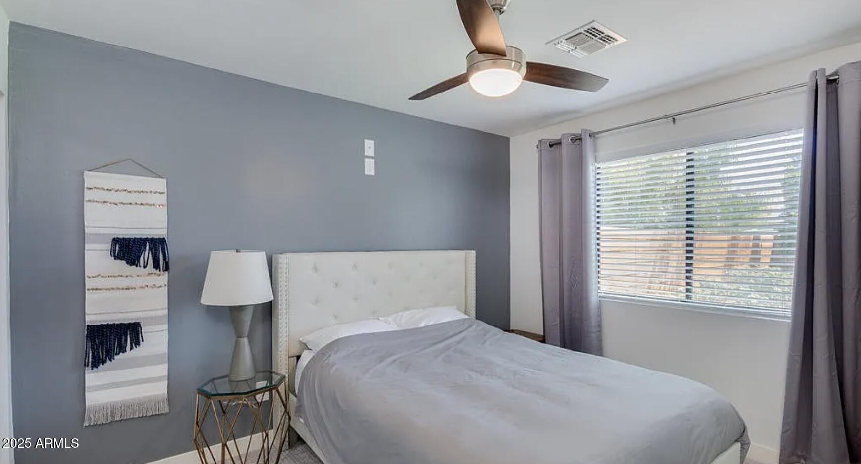 1101 East Weldon Avenue Phoenix, AZ 85014 - Photo 4 of 9 a bedroom with a bed and a chandelier