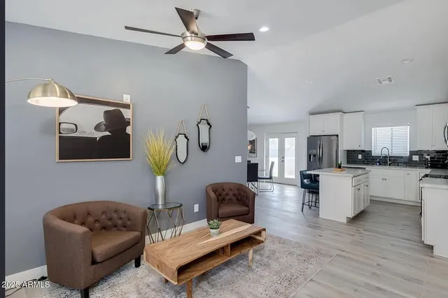 a living room with furniture and kitchen view