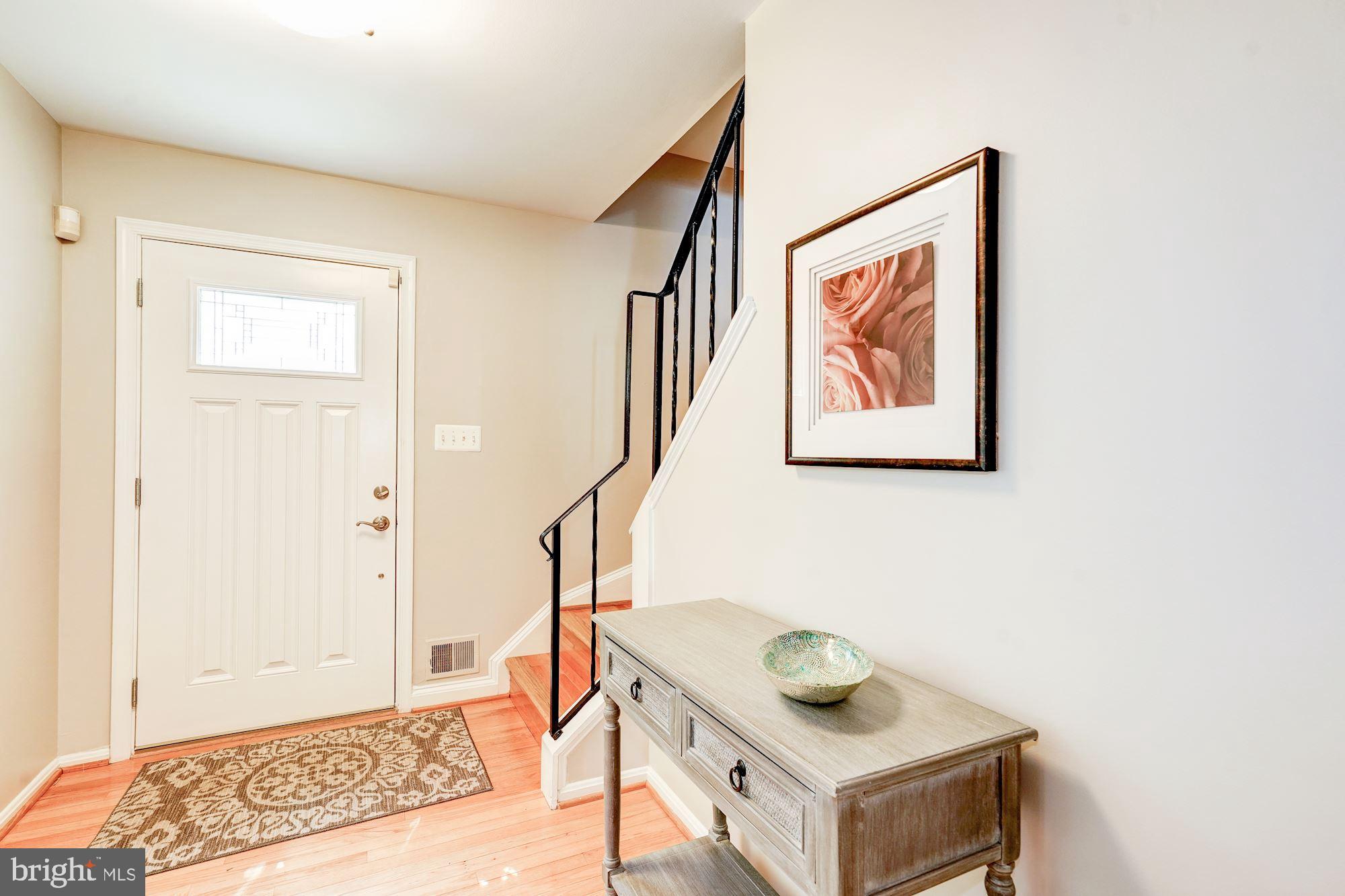 Bright foyer with hardwood floors