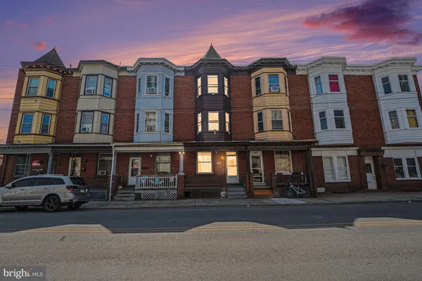a front view of a residential apartment building with a yard