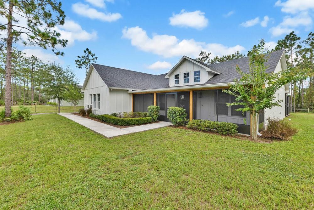 9054 Lincoln Road St. Cloud, FL 34773 - Photo 1 of 33 a front view of a house with a yard and garage