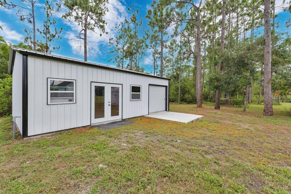 9054 Lincoln Road St. Cloud, FL 34773 - Photo 27 of 33 a view of a house with backyard and tree