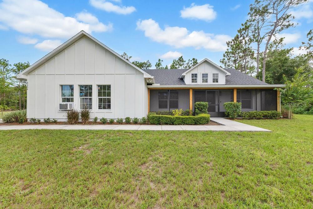 9054 Lincoln Road St. Cloud, FL 34773 - Photo 3 of 33 a front view of a house with a yard