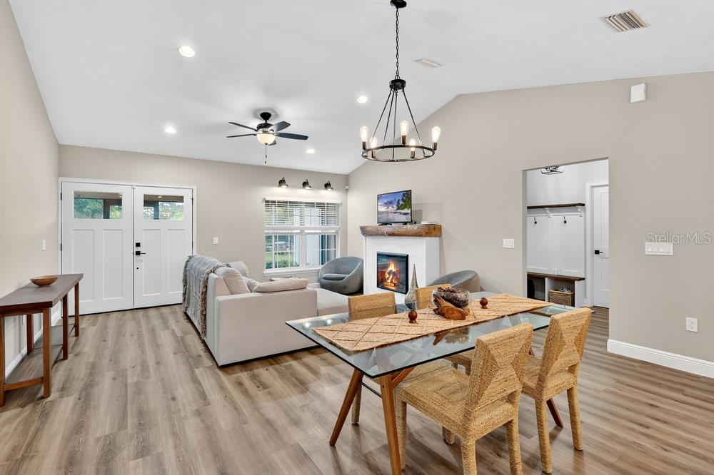 9054 Lincoln Road St. Cloud, FL 34773 - Photo 5 of 33 a living room with a dining table wooden floor and a chandelier