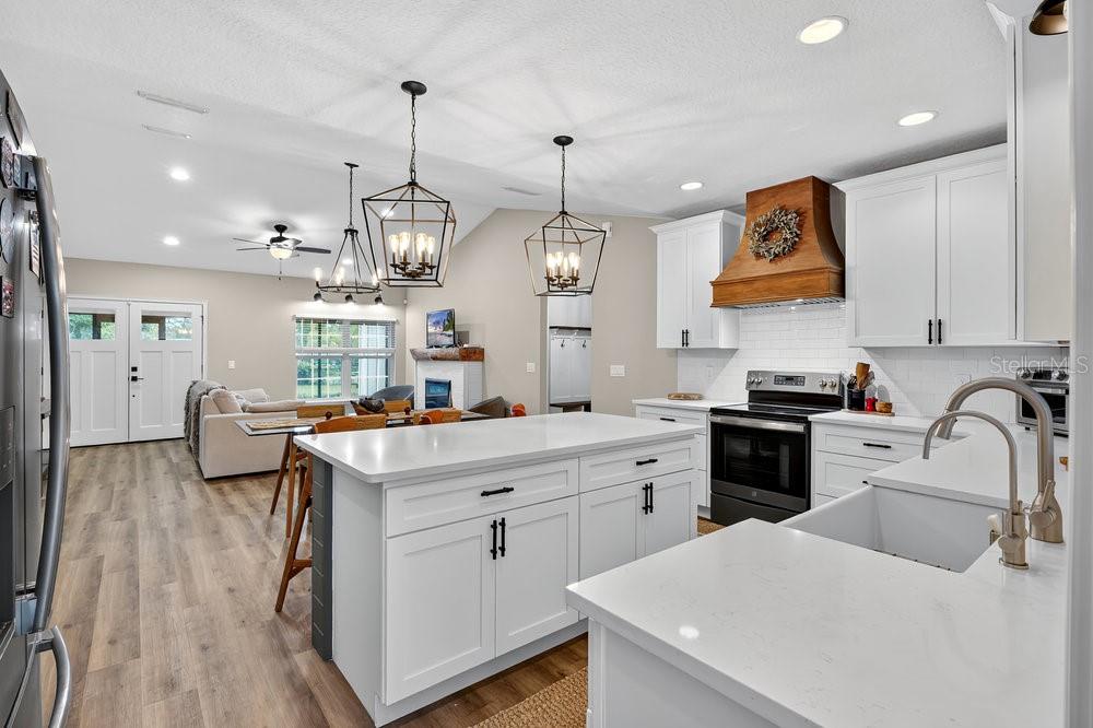 9054 Lincoln Road St. Cloud, FL 34773 - Photo 10 of 33 a kitchen that has a lot of cabinets in it and wooden floors