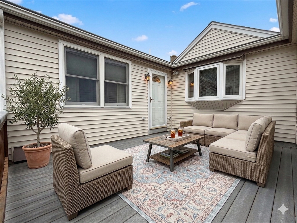 22 Oakdale Road Canton, MA 02021 - Photo 24 of 25 a balcony with furniture and a potted plant