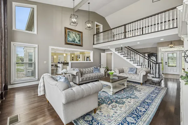 a living room with furniture and a ceiling fan