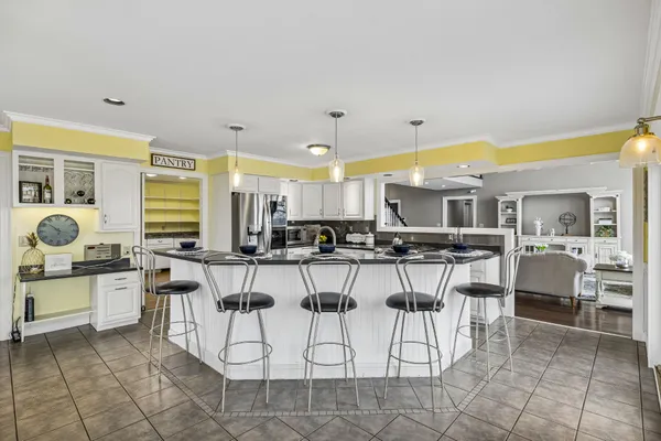a bathroom with a sink and mirror with bathtub