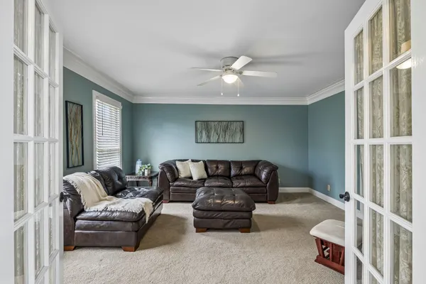 a bedroom with a bed lamp and a window