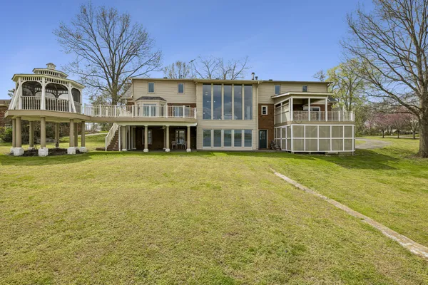 a living room with furniture and large windows