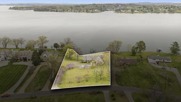 a living room with furniture and floor to ceiling windows