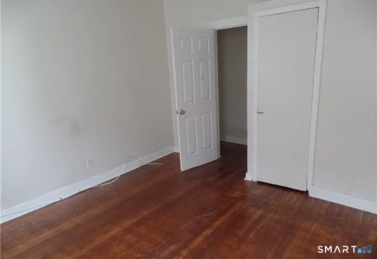 99 Madison Avenue Bridgeport, CT 06604 - Photo 2 of 3 a view of a room with wooden floor and white doors