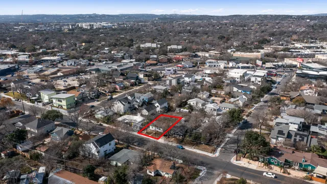 an aerial view of residential houses with city view