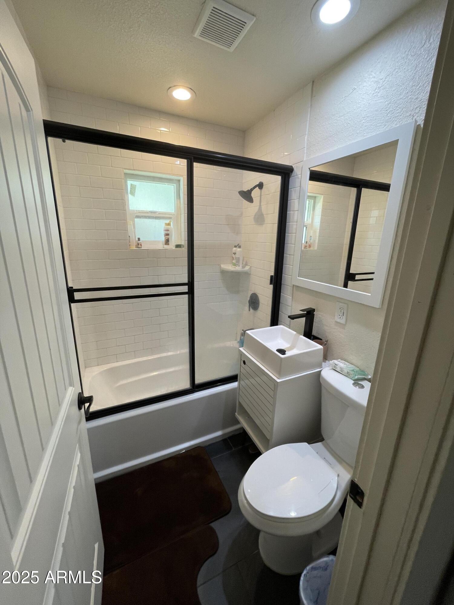 5963 West Ocotillo Road Glendale, AZ 85301 - Photo 4 of 12 a white toilet sitting next to a bathroom sink