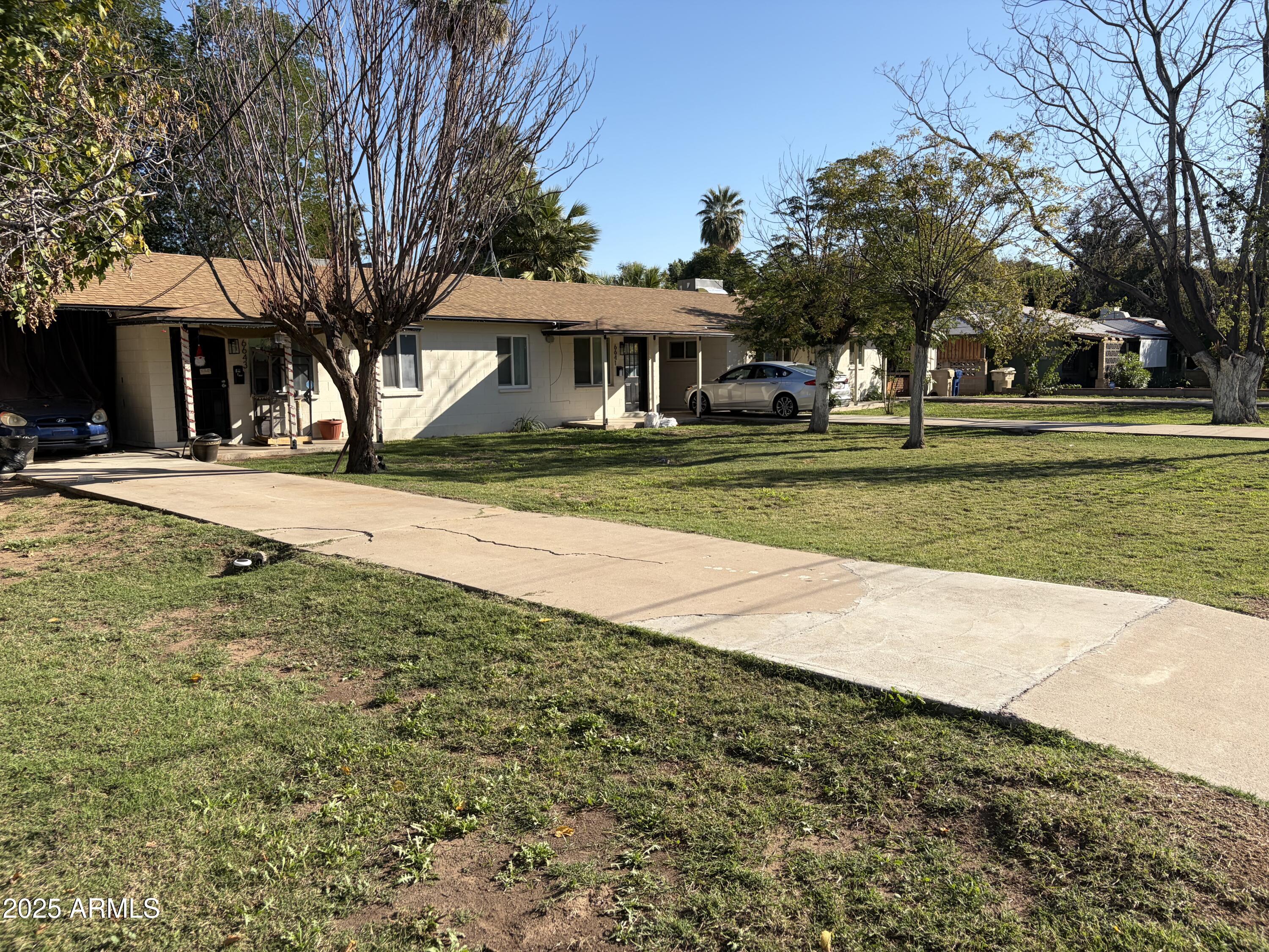 5963 West Ocotillo Road Glendale, AZ 85301 - Photo 7 of 12 a front view of a house with a yard and garage